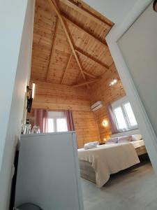 a bedroom with a bed in a room with wooden ceilings at Elafonisos Isle B1 in Elafonisos