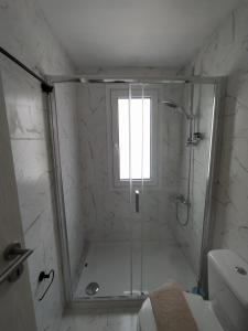 a bathroom with a shower with a window at Elafonisos Isle B1 in Elafonisos