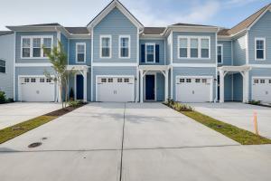 a large blue house with a driveway at North Myrtle Beach Townhome with Pool and Golf Access in Myrtle Beach