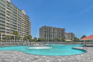 an empty swimming pool with buildings in the background at North Myrtle Beach Townhome with Pool and Golf Access in Myrtle Beach