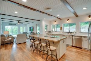 a kitchen with a large island with bar stools at Secluded Marathon Hideaway w/ Fire Pit + Views! in Marathon