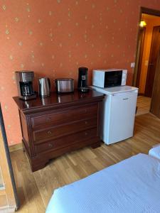 a hotel room with a coffee maker and a microwave at Les Combes in Murat-le-Quaire