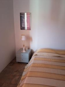 a bedroom with a bed and a table with a lamp at Buen Retiro in Portoferraio