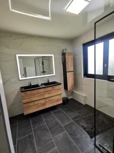 a bathroom with a sink and a mirror at Calme entre pins et océan in Onesse-et-Laharie