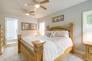 a bedroom with a large bed with a ceiling fan at Vacation Rental House Situated on Chesapeake Bay in Ridge