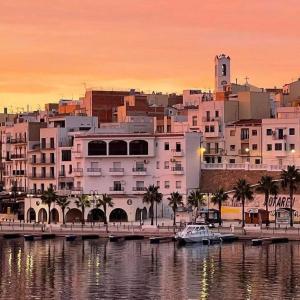 a view of a city with a boat in the water at Nautic in L'Ametlla de Mar +57 photos
