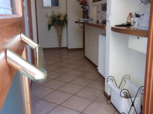 a small kitchen with a tiled floor and a counter at La Fonte Guest House in Sirolo