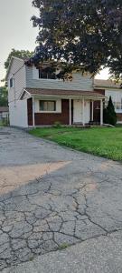 a house with a cracked road in front of it at Lovely apartment house in Grimsby