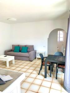a living room with a couch and a table at Casa Gato in Corralejo