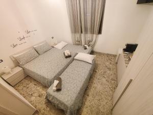 a bedroom with two beds with shoes on them at Villa Turicchio in Taranto
