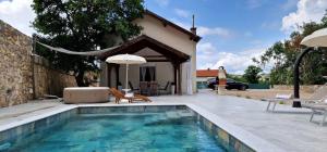 a swimming pool in front of a house at House KID in Bribir