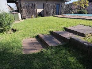 a set of steps in a yard with grass at The Private and Cosy Guest House 1 in Germiston