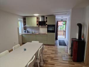 a kitchen and dining room with a table and chairs at Apartma Tija in Tolmin
