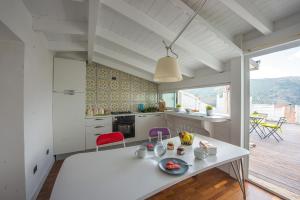a kitchen with a white table and chairs in a room at Casa Tommasini in Capaccio-Paestum
