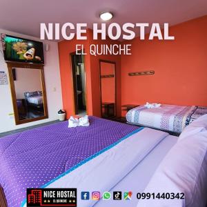 two beds in a room with a nike hospital el camino at Nice Hostal El Quinche in Quinche