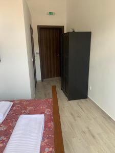 a bedroom with a bed and a closet and a door at Rajski Horizonti - Rooms Ram I in Ram