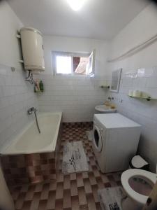 a bathroom with a tub and a toilet and a sink at Centar Apartment in Gevgelija