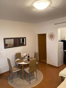 a dining room with a table and chairs at Apartmani Ines in Marina