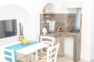 a kitchen with a table and chairs and a counter at Borgo Albergo Capozzi 39 in Monopoli
