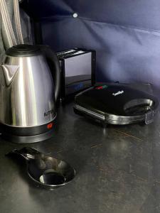 a blender and a toaster sitting on a counter at Elia Glamping in Stepantsminda