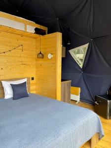 a bedroom with a bed in a tent at Elia Glamping in Stepantsminda