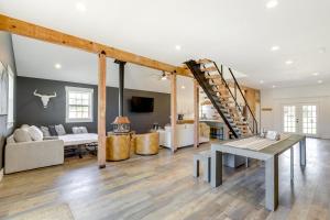 a living room with a staircase and a couch at Orangeville Vacation Rental with On-Site Creek! in Orangeville