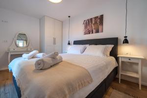 a bedroom with a large bed with a teddy bear on it at Shee-Lu Suites in Dubrovnik
