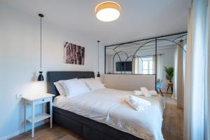 a bedroom with a bed with a large mirror above it at Shee-Lu Suites in Dubrovnik