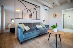 a living room with a blue couch and a table at Shee-Lu Suites in Dubrovnik +26 photos