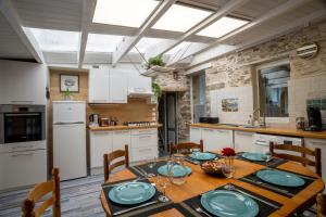 uma cozinha com uma mesa de madeira com placas em maison tartifume em Pornic