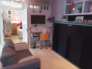 a living room with a large tv and a couch at Apartamento San Quirce - céntrico y reformado- wifi y netflix in Valladolid