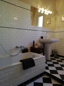 a bathroom with a bath tub and a sink at Rooms by Anna in Florence