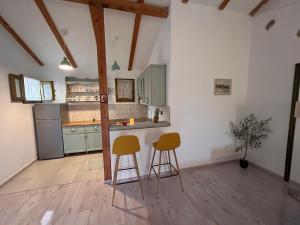 a kitchen with two chairs and a counter in a room at Gaya apartments in Šibenik