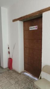 una puerta de garaje marrón con un cartel. en Casa Flores en Zacatecas