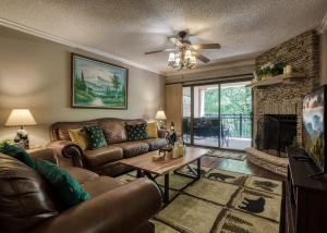 a living room with a couch and a fireplace at Gatehouse 203 - Great Condos Just outside downtown Gatlinburg! condo in Gatlinburg