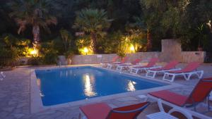 a swimming pool with lounge chairs and a swimming pool at Residence Helios in Cargèse