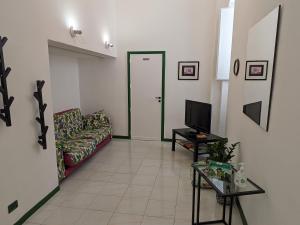 a living room with a couch and a tv at Casa Ficumora in Modica