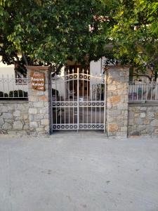 a gate with a sign in front of a building at Pansion Matoula in Skiathos