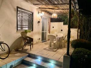 a patio with a table and chairs and a window at Seconda stella a destra in Taranto +12 photos