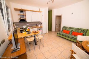 a kitchen and living room with a table and a couch at Seconda stella a destra in Taranto