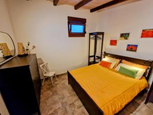 a bedroom with a bed and a dresser in it at Pixie House - Mrežnica, private pier, hot tub in Gornji Zvečaj +41 photos
