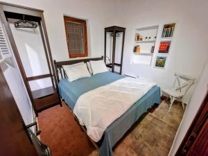 a bedroom with a bed and a chair in it at Pixie House - Mrežnica, private pier, hot tub in Gornji Zvečaj