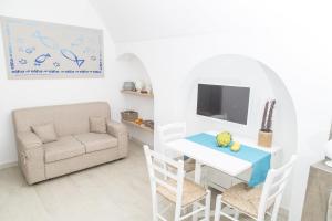 a living room with a table and a chair and a couch at Borgo Albergo Capozzi 39 in Monopoli