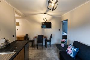 a living room and kitchen with a table and a couch at K&M Villas in Nea Kallikrateia