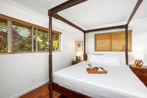 a bedroom with a bed with a wooden frame at KBM Resorts International Colony Club ICC-11 2Bdm in Kaanapali