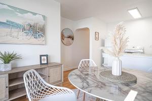 a dining room with a table and chairs at Waterfront Bliss, 2 BR Apt near Alki Beach in Seattle
