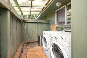 a washer and dryer in a green laundry room at KBM Resorts International Colony Club ICC-11 2Bdm in Kaanapali