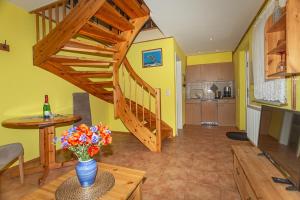 a living room with a staircase and a vase of flowers at Ferienhaus Boddenhus in Middelhagen