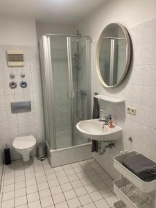a bathroom with a shower and a sink and a toilet at Schöne, helle Wohnung im Zentrum in Münster