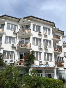 a large white building with balconies on it at Hotel Palma Weiss in Kranevo